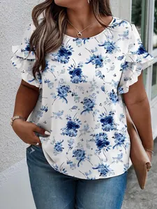 Detailed view of blue floral print and ruffled sleeves on white plus-size summer top