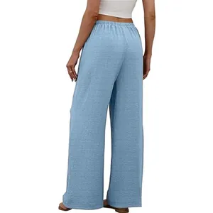 Back view of women's light blue wide-leg casual beach trousers with elastic waist.