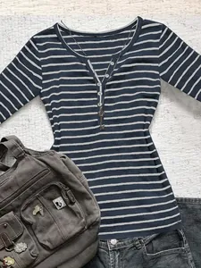 Detailed view of the navy and white striped slim-fit shirt with Henley button neck