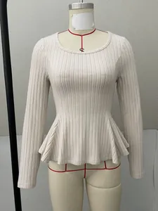 Detailed shot of cream ribbed knit long sleeve base shirt with elegant peplum ruffle hem