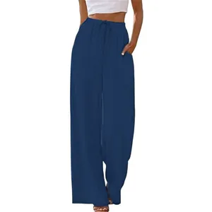 Detail view of navy blue wide-leg trousers featuring drawstring elastic waist and side pockets