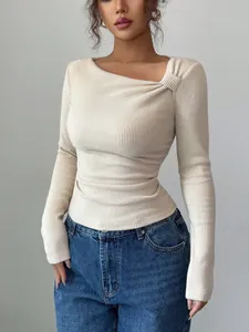 Detail view showing unique pleated irregular neck design on cream ribbed long-sleeve top