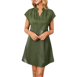 Detail showing texture contrast of faux suede and PU leather on green mini dress