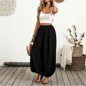 Full view of women's black high-waisted lantern pants for beach vacation style