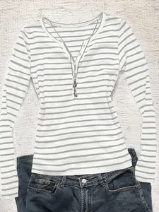 Flat lay view of a women's striped long sleeve Henley t-shirt with button detail