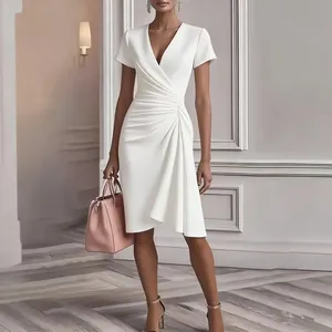 Elegant white V-neck dress detail featuring intricate waist pleats and slim fit