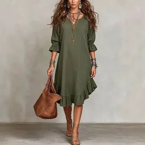 Elegant olive green woven midi dress featuring V-neck and ruffled hem for boho look