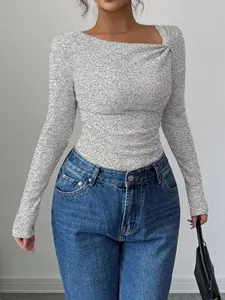 Close-up of grey ribbed top with asymmetrical neckline and elegant pleated details