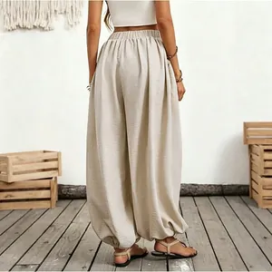 Detailed back view of these beige high waist lantern pants for a beach vacation style outfit