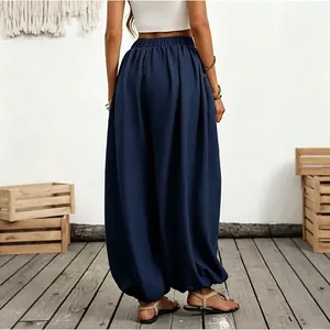 Back view detail of navy blue high-waisted harem pants with elastic ankle cuffs
