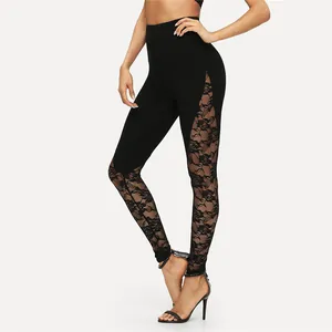 Detailed close-up view of black yoga leggings with elegant floral lace hollow patchwork design.