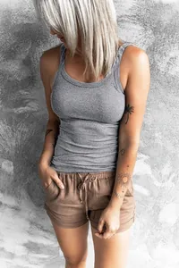 Women's slim-fit grey ribbed tank top shown on model with casual shorts