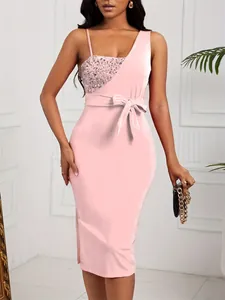 Detail view of a pink one-shoulder evening dress featuring sequins and a waist bow
