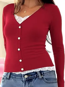Close-up of red ribbed knit top with white lace hem and elegant button closure
