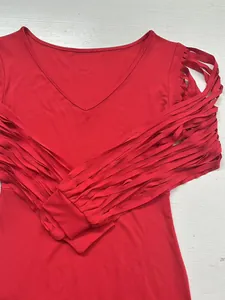Detailed shot of red V-neck party dress featuring dramatic fringe tassel sleeves
