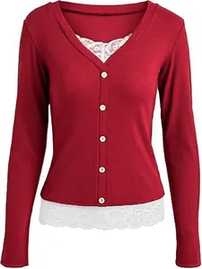 Close-up of red V-neck long-sleeve top with white lace hem and buttons detail.