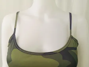 Detail shot of the neckline and shoulder straps of a camouflage pattern summer camisole dress