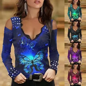Women's cold shoulder long sleeve top with butterfly print and lace trim detail.