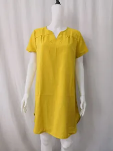 Detail shot of the yellow cotton linen dress featuring a relaxed fit and V-neckline