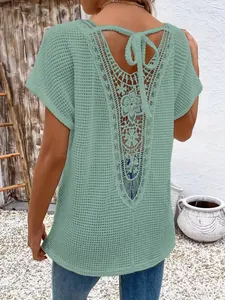 Back detail view of women's sage green knit top with floral lace hollow-out and tie