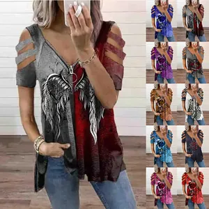 Detail view of women's V-neck t-shirt with cutout sleeves and varied graphic prints