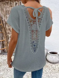 Detailed back view of grey short sleeve T-shirt featuring lace hollow-out and V-neck tie
