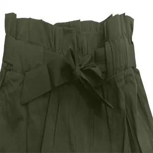 Detailed macro view of high-waisted paperbag shorts with a tied bow belt in olive green.