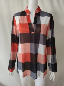 Front view of plaid women's long-sleeve shirt with orange and black geometric pattern