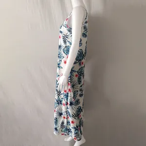 Side view of a white tropical palm leaf print sleeveless maxi dress on mannequin
