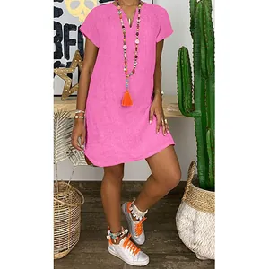 Pink V-neck short sleeve loose woven dress styled with boho accessories and desert cactus