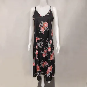 Close-up detail of black summer slip dress with vibrant red rose floral pattern