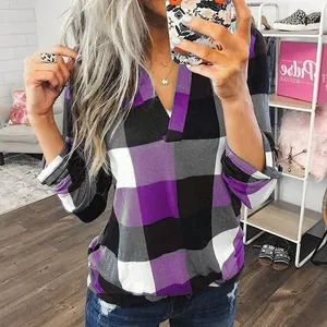 Detailed look at purple and black plaid pattern on a women's V-neck long sleeve shirt
