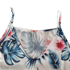 Close-up detail of a tropical floral print V-neck camisole dress with thin spaghetti straps