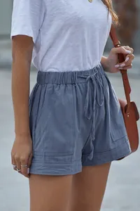 Detail shot of women's dusty blue high-waisted casual shorts with drawstring waist
