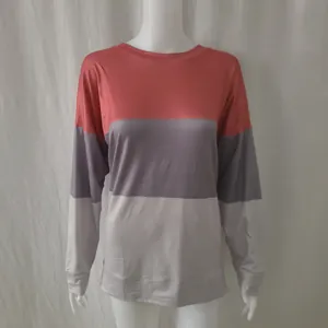 Casual long-sleeved sweatshirt featuring coral and grey color-block design on mannequin