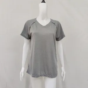 Detailed view of women's grey short-sleeved V-neck T-shirt with loose fit on mannequin