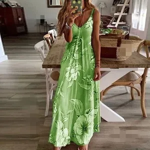 Full-length view of a green floral maxi dress with spaghetti straps in a mirror selfie style.