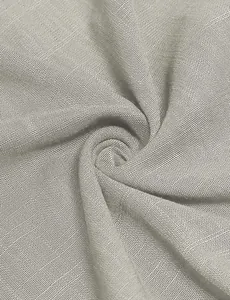 Detailed macro view of breathable light grey woven fabric texture for a summer dress.