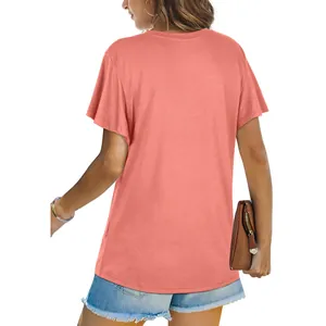 Back view of a comfortable coral short sleeve t-shirt styled with denim shorts