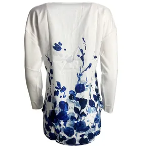 Detailed back view of a white long sleeve blouse with elegant blue floral prints
