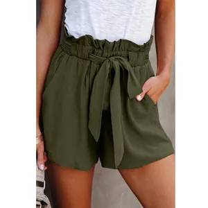 Close-up of olive green paperbag waist shorts with tie belt and side pockets