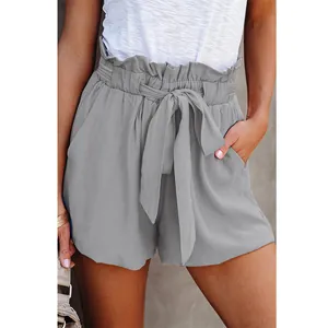 Close-up detail of women's grey paperbag waist shorts with adjustable bow tie and pockets