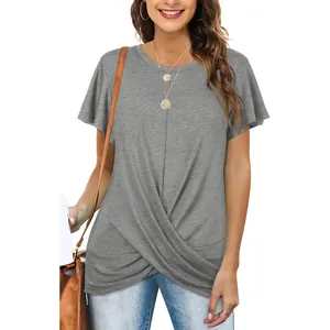 A detailed view of a woman wearing a grey t-shirt with a front twist knot and flared sleeves.