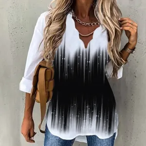 Detailed view of the wave neckline and black white gradient print on a long sleeve shirt