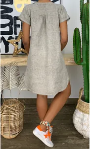 Back view of a loose grey short-sleeved linen-textured woven dress with pleat detail