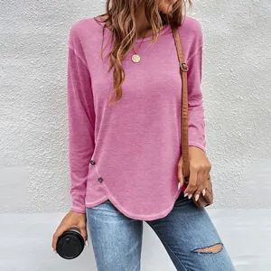Casual pink long-sleeve t-shirt with irregular hem and decorative button details.