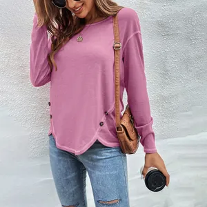 Close-up of mauve long sleeve top featuring irregular hem and button detail on side