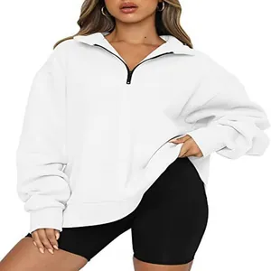 Detailed view of women's white half-zip sweatshirt with ribbed cuffs and relaxed fit.