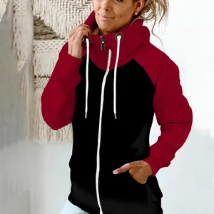 Close-up of a women's red and black color-block high-neck hoodie with white zipper