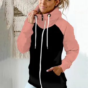 Close-up detail of the pink and black two-tone zip-up hoodie featuring a high neck design